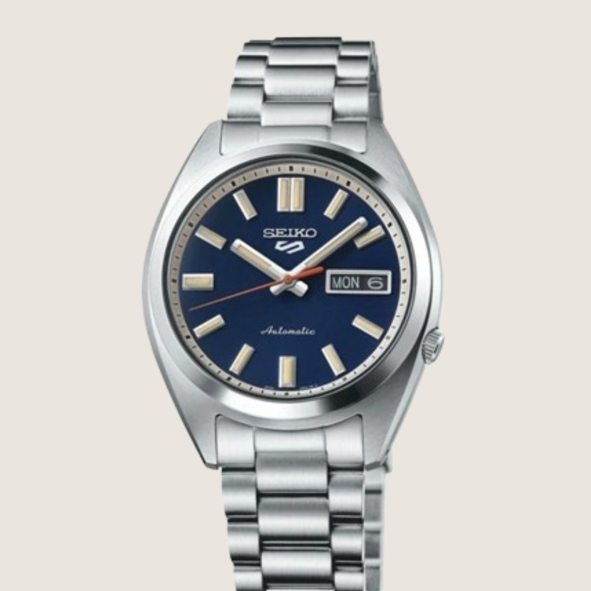 Seiko 5 Sports SNXS SRPK87K1, blue sunburst dial and steel bracelet, on a plain bone background