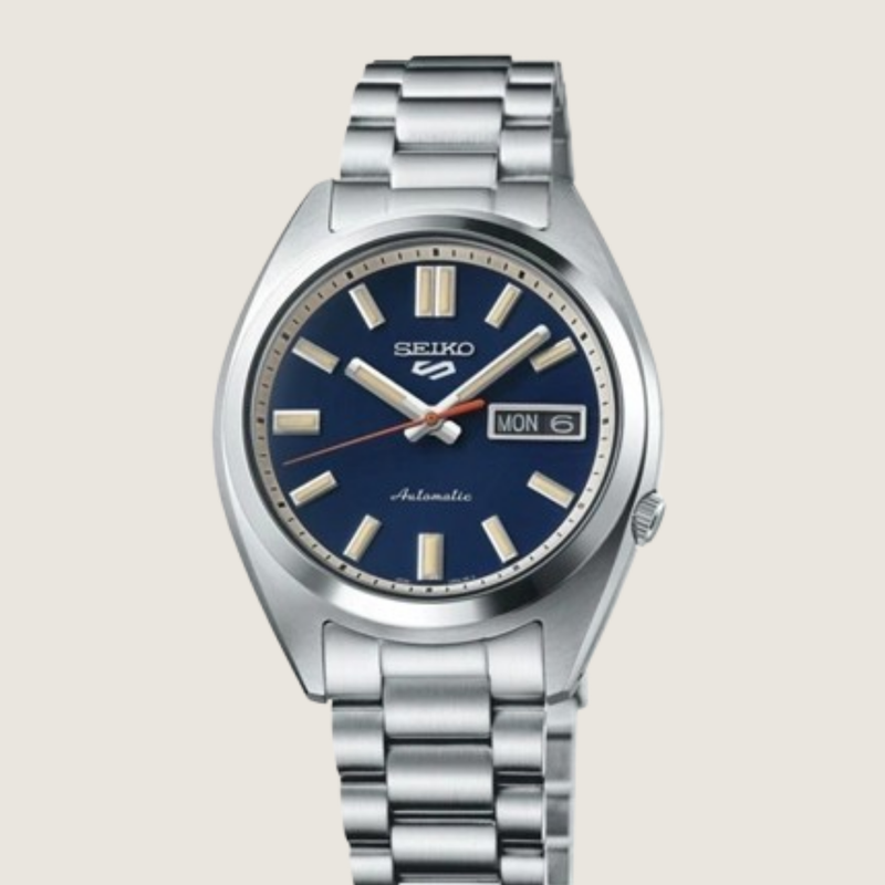 Seiko 5 Sports SNXS SRPK87K1, blue sunburst dial and steel bracelet, on a plain bone background