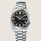 Seiko 5 Sports SNXS SRPK89K1, black sunburst dial and steel bracelet, on a plain bone background