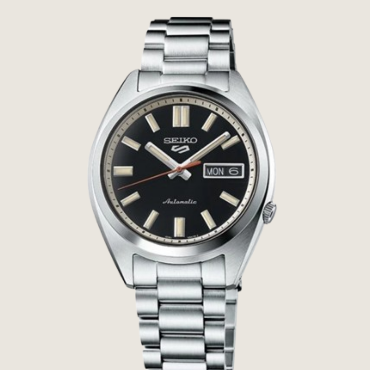Seiko 5 Sports SNXS SRPK89K1, black sunburst dial and steel bracelet, on a plain bone background
