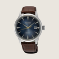 Seiko Presage Midnight Blue Moon SRPK15J1, blue sunburst dial and brown leather strap, on a plain bone background