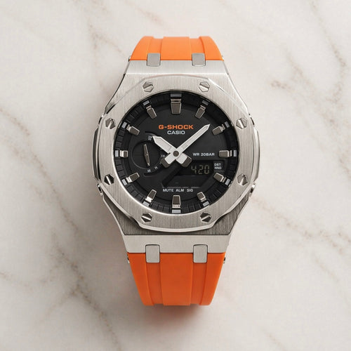 G-Shock Casio watch with orange strap on a marble surface