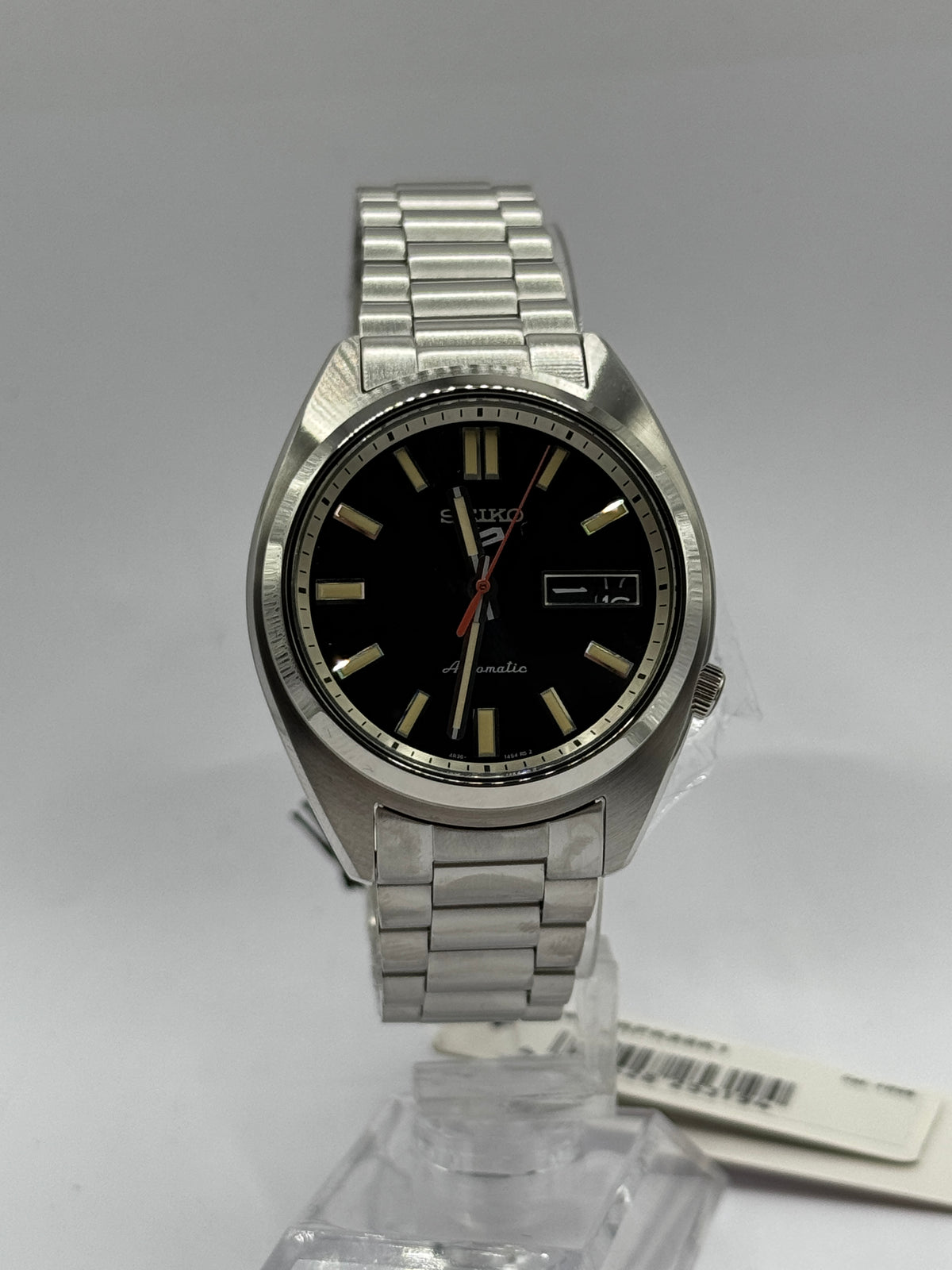 Seiko 5 Sports SNXS SRPK89K1, black dial front view with swing tag