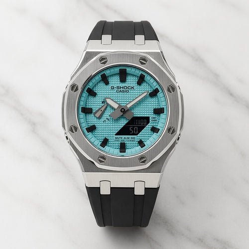 G-Shock watch with blue face and black strap on marble background