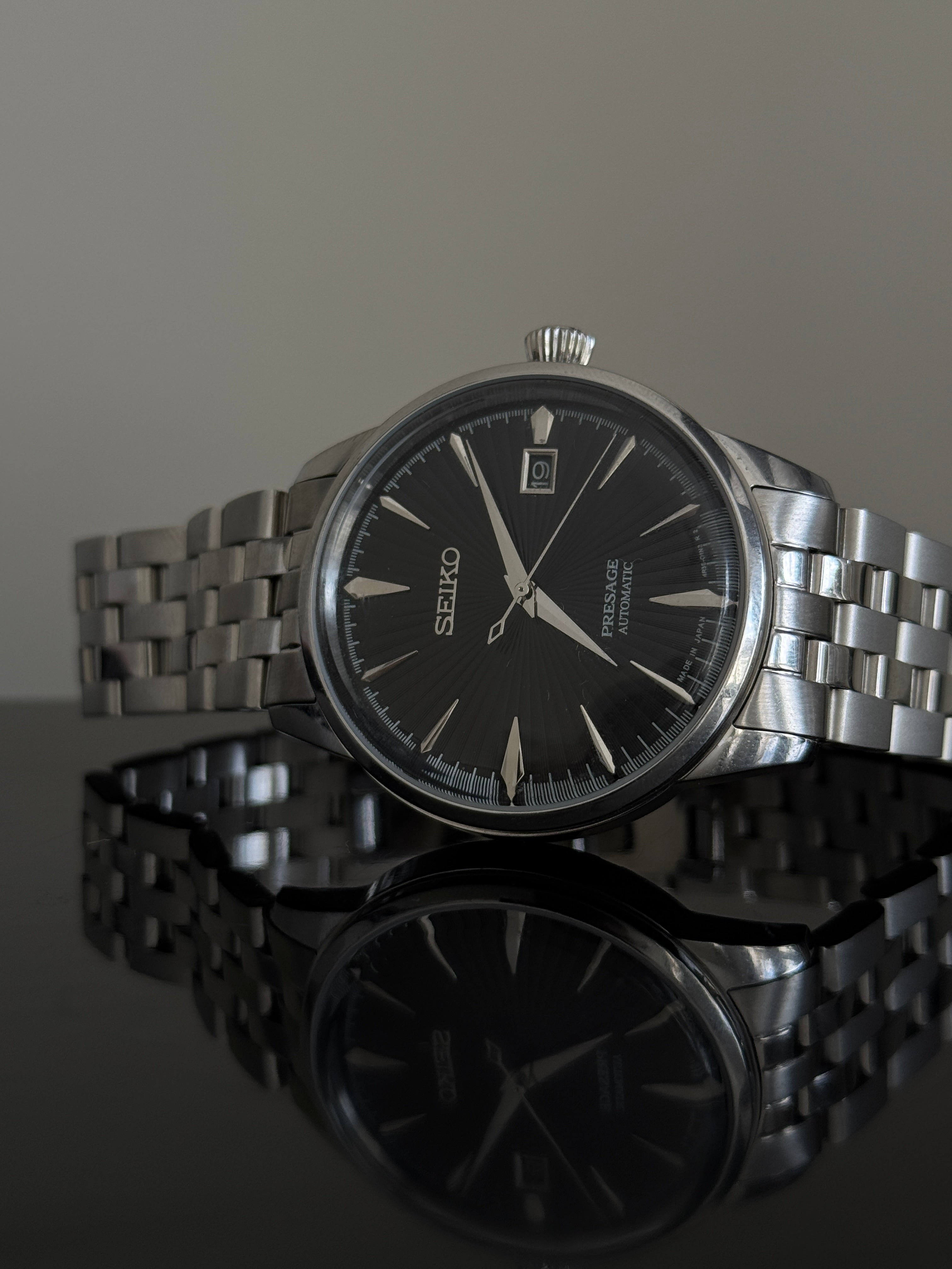 Seiko Presage Cocktail Time SRPE17J1 — black sunburst dial, stainless steel bracelet, front view
