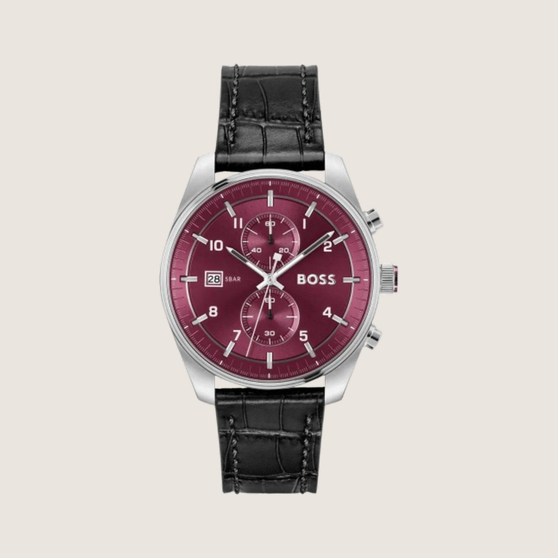 Hugo BOSS Skytraveller chronograph with deep burgundy dial and black croc-effect leather strap, on a plain bone background