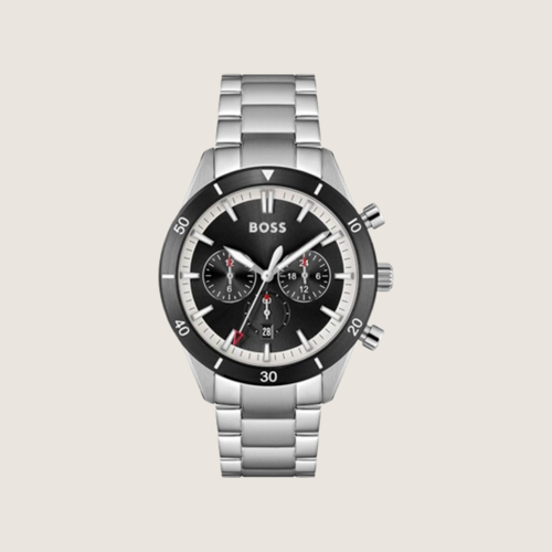 Hugo BOSS chronograph with black dial, red accents, black bezel and stainless steel bracelet, on a plain bone background