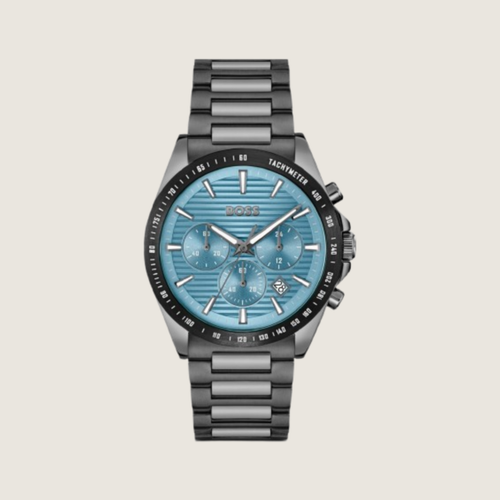 Hugo BOSS chronograph with pale blue tachymeter dial and dark gunmetal bracelet, on a plain bone background