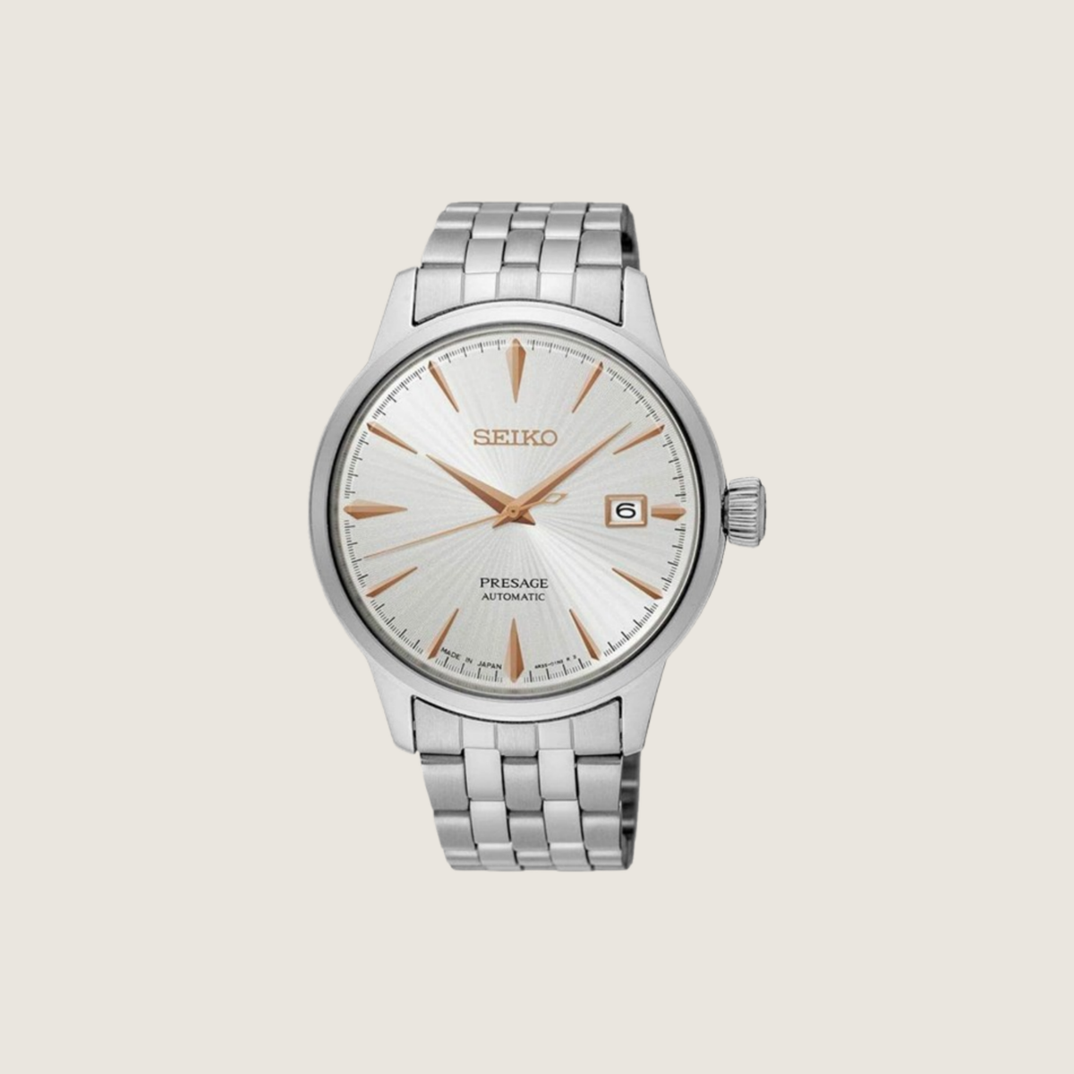 Seiko Presage Cocktail Time with silver sunburst dial, rose gold hands and indices on a stainless steel bracelet, on a plain bone background
