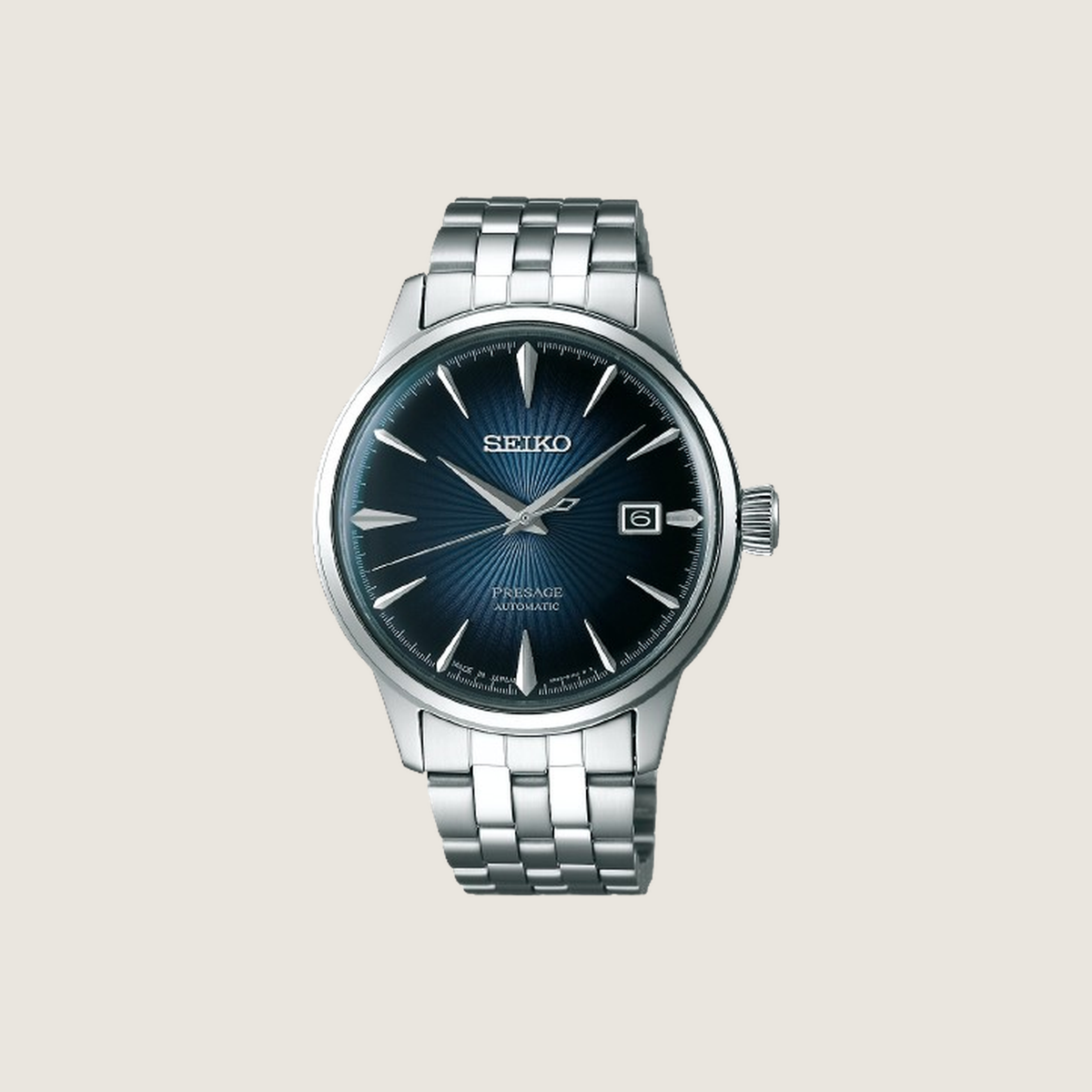 Seiko Presage Blue Moon SRPB41J1, deep navy sunburst dial and steel bracelet, on a plain bone background