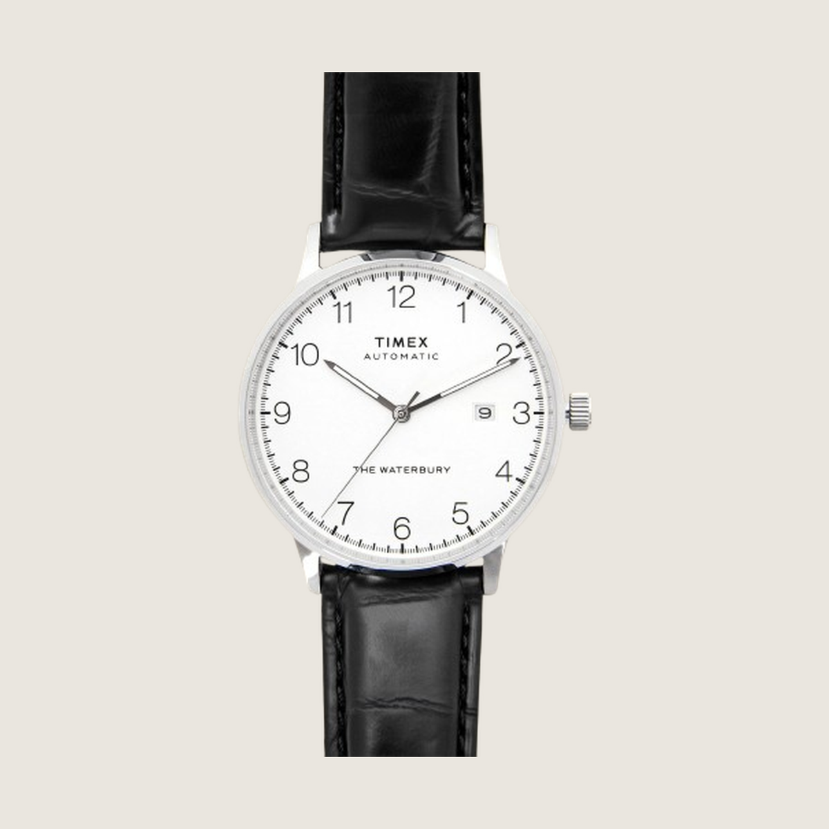Timex Waterbury Automatic with classic white dial and black onyx leather strap, on a plain bone background